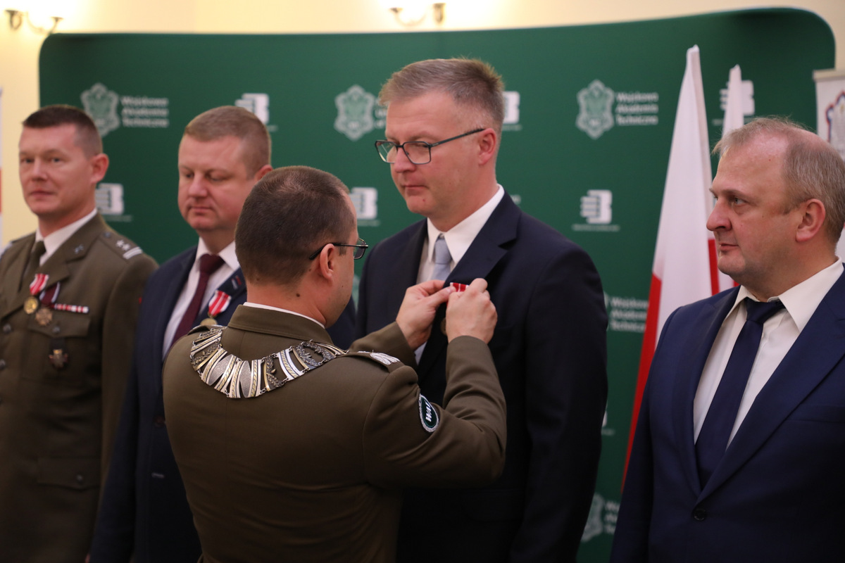 Fot. 2. Rektor-Komendant przypina odznaczenie do klapy marynarki Arkadiusza Rubca.