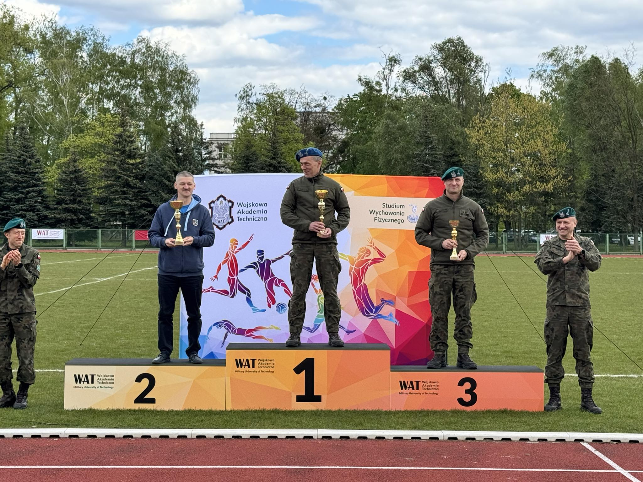 Reprezentanci zwycięzkich wydziałów pozują na podium.