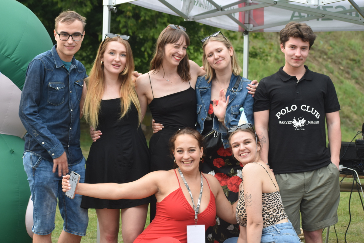 Piknik WIM i WML - na zdjęciu osoby stoją na polanie, na trawie, w tle namioty z napisami WAT.